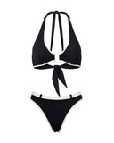 Flat lay display of a black retro halter bikini top and matching belted bottoms with white piping details.