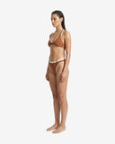 Side profile of the Ursula brown bikini showcasing the soft rib nylon fabric and the contrasting ivory waist belt.