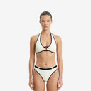 Front view of a model wearing the Ursula 2P ivory and black bikini set featuring a retro halter top and high-rise belted bottoms.