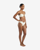Side profile of the ivory bandeau bikini showcasing the supportive fit and high-waisted textured bottoms from the Bali beachwear collection.