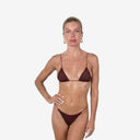 Front view of a model wearing a cherry red triangle bikini set with a unique mesh fabric overlay and slim adjustable straps.