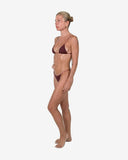 Side profile of the cherry red bikini highlighting the low-rise fit and the combination of biflex and mesh net fabrics.