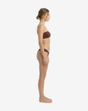 Side profile of the dark red strapless bikini showcasing the stretchy biflex fabric and high-cut leg silhouette