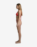 Side profile of the red basic silhouette bikini showcasing the thin adjustable straps designed to minimize tan lines