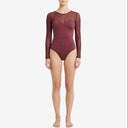 Front view of a model wearing a cherry red long-sleeve swimwear piece featuring a sleek V-neckline and durable biflex fabric.