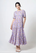 Woman wearing a purple floral dress on a white background
