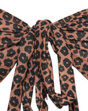 Close-up of the animal print tan-through fabric on the bandeau bikini top, showcasing the detailed leopard pattern and soft texture.