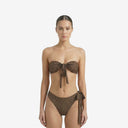 Front view of a model wearing a Les Nenettes leopard-print bikini set, featuring an adjustable bandeau top with front-tie detail and high-waisted thong bottoms
