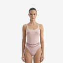 Front view of a model wearing the Lara pink one-piece swimsuit featuring starfish embroidery on the bust and removable beaded waist details.