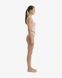 Side profile of the Lara pink swimsuit showcasing the high-cut leg design for a natural BBL effect and sleek tan-through fabric