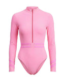 Bali surf wear store featuring a pink long-sleeve one-piece swimsuit with UPF 50+ protection, front zipper detail, and quick-drying performance material.