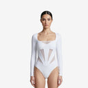 Front view of a model wearing the Rose white long-sleeve bodysuit swimsuit with a square neckline and geometric mesh paneling.