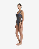 Side profile of a model showing the transparent mesh cut-out details on a dark grey bodysuit.
