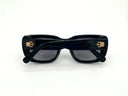 Black sunglasses with dark lenses on a white background