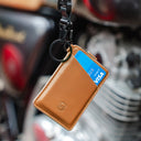 Close-up of the camel-colored Draft8 minimalist leather cardholder with pull tab and ring loop for efficient daily use.