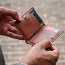 Front view of green Draft-8 LOCAL leather wallet with embossed logo.
