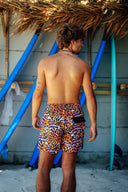Back view of the wild vibes men's shorts highlighting the functional back pocket for convenient beach storage.
