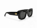 Black sunglasses with dark lenses on a white background